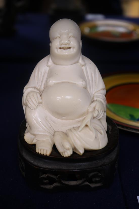 A Chinese ivory figure of Budai wood stand